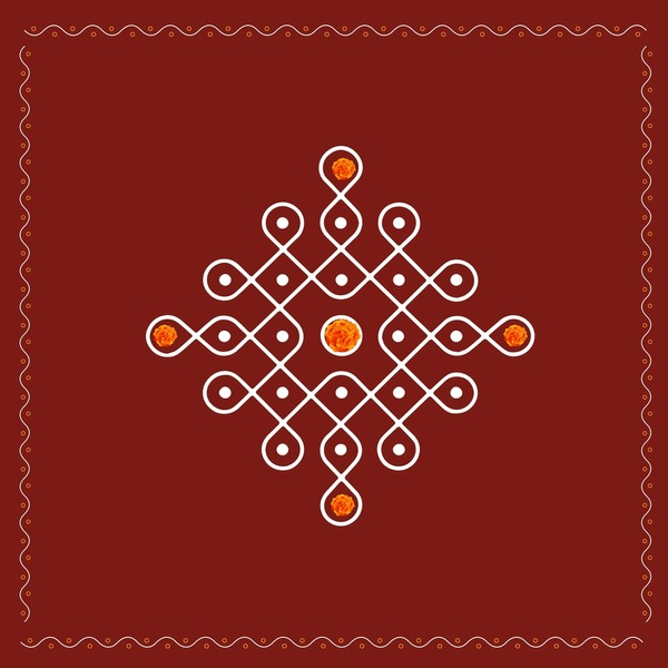 Traditional pulli kolam with white interlaced lines and marigold accents
